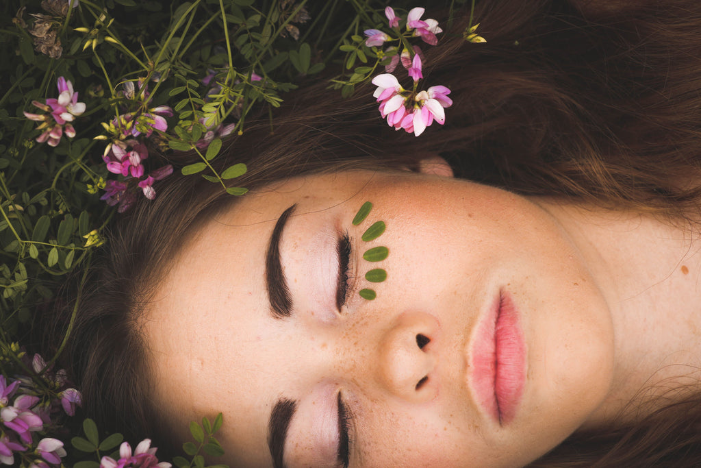 brunette girl laying in botanicals and flowers